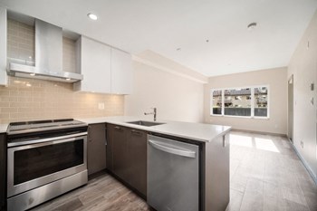 Spacious kitchen including stainless steel appliance package.